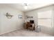 Cozy bedroom features neutral striped wallpaper, wood desk, and shelving at 12826 S 40Th Pl, Phoenix, AZ 85044