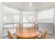 Bright breakfast nook with a round wooden table surrounded by large windows, offering an inviting dining space at 12826 S 40Th Pl, Phoenix, AZ 85044