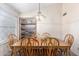 Bright dining room with wooden table and chairs, complemented by a built-in display shelf and stylish chandelier at 12826 S 40Th Pl, Phoenix, AZ 85044