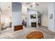 Open-concept living room featuring a fireplace, carpeted floors, and stainless steel kitchen appliances at 12826 S 40Th Pl, Phoenix, AZ 85044