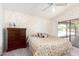 Main bedroom with patterned wallpaper, a comfortable bed, and sliding glass doors leading to an outdoor patio at 12826 S 40Th Pl, Phoenix, AZ 85044