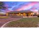 Spacious backyard featuring a built-in fireplace and covered patio perfect for entertaining under a twilight sky at 13007 W Tuckey Ct, Glendale, AZ 85307