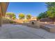 Expansive backyard with concrete, outdoor fireplace, grill, and well-kept landscaping at 13007 W Tuckey Ct, Glendale, AZ 85307