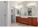 Bright bathroom features dual sinks, walk-in closet, and neutral tile flooring at 13007 W Tuckey Ct, Glendale, AZ 85307