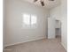 Neutral bedroom showcasing a window with white shutters, and carpet, and access to the closet with white door at 13007 W Tuckey Ct, Glendale, AZ 85307