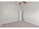 Bright, carpeted bedroom with open doorway to the next room at 13007 W Tuckey Ct, Glendale, AZ 85307