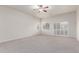 Bedroom featuring carpet, ceiling fan, and large windows with shutter coverings at 13007 W Tuckey Ct, Glendale, AZ 85307