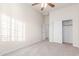 Spacious carpeted bedroom with abundant natural light, providing entry to an adjoined closet with sliding doors at 13007 W Tuckey Ct, Glendale, AZ 85307