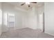 Well-lit bedroom displaying neutral walls, carpet, and two door openings for accessibility and convenience at 13007 W Tuckey Ct, Glendale, AZ 85307