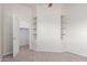 Bedroom with a carpeted floor, shelves and access to the walk-in closet at 13007 W Tuckey Ct, Glendale, AZ 85307