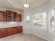 Breakfast nook with tile flooring, bay windows with shutters, and built-in cabinets at 13007 W Tuckey Ct, Glendale, AZ 85307