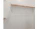 Close-up of a walk-in closet featuring wooden rods and white shelving at 13007 W Tuckey Ct, Glendale, AZ 85307