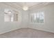 Bright dining area with a modern chandelier, shutters, and adjacent living spaces at 13007 W Tuckey Ct, Glendale, AZ 85307