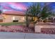 Charming single-story home featuring desert landscaping and stone accents at 13007 W Tuckey Ct, Glendale, AZ 85307