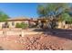 Inviting single-story home featuring desert landscaping, stone accents, and lush landscaping at 13007 W Tuckey Ct, Glendale, AZ 85307