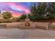 Outdoor fireplace with stone surround and built-in bench seating perfect for cool evenings at 13007 W Tuckey Ct, Glendale, AZ 85307