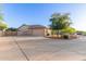 Beautiful home featuring a spacious driveway, three-car garage, and desert landscaping at 13007 W Tuckey Ct, Glendale, AZ 85307