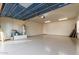 Spacious three-car garage features epoxy flooring, ample lighting, and two access doors at 13007 W Tuckey Ct, Glendale, AZ 85307
