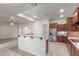 Open kitchen with breakfast bar, stainless steel appliances, and tiled floor at 13007 W Tuckey Ct, Glendale, AZ 85307