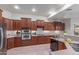Spacious kitchen features stainless steel appliances, granite countertops, and ample cabinet space at 13007 W Tuckey Ct, Glendale, AZ 85307