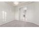 Bright living room with carpet, archway, and decorative lighting fixture at 13007 W Tuckey Ct, Glendale, AZ 85307