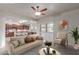 Inviting living room flows into an open kitchen with breakfast bar and modern appliances at 13007 W Tuckey Ct, Glendale, AZ 85307