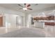 Open-concept living room with tile flooring, neutral walls, and views of the kitchen and entryway at 13007 W Tuckey Ct, Glendale, AZ 85307