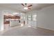 Spacious living room with tile flooring, plantation shutters, and a view to the kitchen at 13007 W Tuckey Ct, Glendale, AZ 85307
