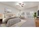 Serene bedroom with plush carpeting, plantation shutters, and ample natural light at 13007 W Tuckey Ct, Glendale, AZ 85307