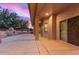 Covered patio showcasing an outdoor fireplace, stucco columns and a view of the spacious backyard at 13007 W Tuckey Ct, Glendale, AZ 85307