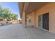 Covered patio showcasing an outdoor fireplace, stucco columns and a view of the spacious backyard at 13007 W Tuckey Ct, Glendale, AZ 85307