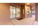 A covered patio with a sliding glass door and windows is perfect for enjoying the outdoors at 13007 W Tuckey Ct, Glendale, AZ 85307