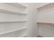 Spacious walk-in closet with ample shelving and carpeted floor at 13007 W Tuckey Ct, Glendale, AZ 85307