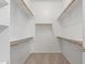 Large walk-in closet with built-in shelves and wooden rods for hanging clothes at 13007 W Tuckey Ct, Glendale, AZ 85307