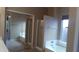 Bright bathroom featuring a soaking tub, separate shower, and mirrored closet at 1306 W Charleston Ave, Phoenix, AZ 85023