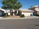 Well-maintained single-story home featuring a lush front yard and a two-car garage at 1306 W Charleston Ave, Phoenix, AZ 85023