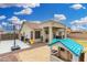 Backyard featuring play structure, basketball court, covered patio, gravel, and a well-maintained lawn at 13308 W Acapulco Ln, Surprise, AZ 85379