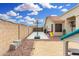 Backyard featuring a basketball court, gravel area, play structure, and block wall for privacy at 13308 W Acapulco Ln, Surprise, AZ 85379