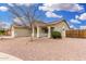 Charming single-story home with a covered porch and desert landscaping for easy upkeep at 13308 W Acapulco Ln, Surprise, AZ 85379