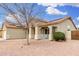 Charming single-story home with a covered porch and desert landscaping for easy upkeep at 13308 W Acapulco Ln, Surprise, AZ 85379