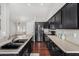 Modern kitchen with stainless steel appliances, dark wood cabinets, and island sink at 13308 W Acapulco Ln, Surprise, AZ 85379