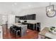 Charming kitchen featuring black cabinets and a kitchen island at 13308 W Acapulco Ln, Surprise, AZ 85379