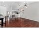 Spacious living room featuring hardwood floors, a modern chandelier, and open layout at 13308 W Acapulco Ln, Surprise, AZ 85379