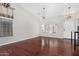 Bright living room with high ceilings, hardwood floors, and natural light from large windows at 13308 W Acapulco Ln, Surprise, AZ 85379