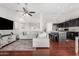 Open-concept living room with a view into the kitchen island with bar stool seating at 13308 W Acapulco Ln, Surprise, AZ 85379