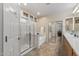 Well-lit bathroom featuring a glass-enclosed shower, soaking tub, and double sink vanity at 13545 W Caribbean Ln, Surprise, AZ 85379