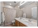 Bathroom showcasing a double sink vanity with a shower-tub combo at 13545 W Caribbean Ln, Surprise, AZ 85379