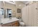 Bathroom featuring single sink vanity, toilet, and bathtub with shower at 13545 W Caribbean Ln, Surprise, AZ 85379