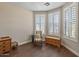 Comfortable bedroom with wooden floors, natural light, and a cozy reading nook at 13545 W Caribbean Ln, Surprise, AZ 85379