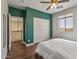 Bedroom with wood flooring, ceiling fan, closet, and an upper level view through doorway at 13545 W Caribbean Ln, Surprise, AZ 85379